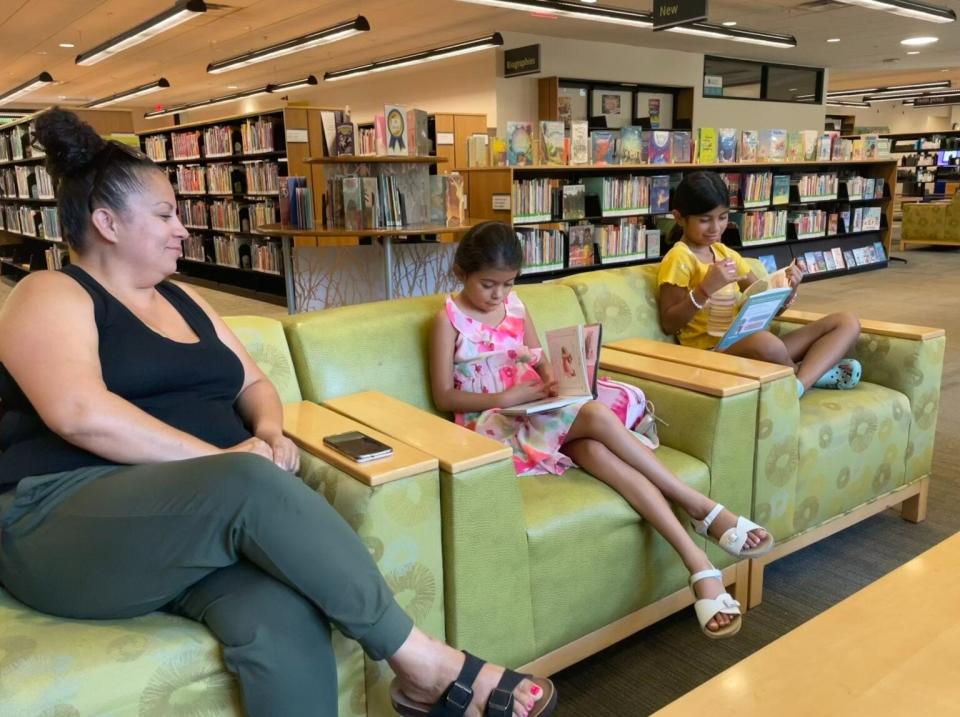 Michelle Diaz brought her daughter, Catalaleya Ruano, center, and her pal, Mariah Orosco, right, to the Gilroy Library to check out books.