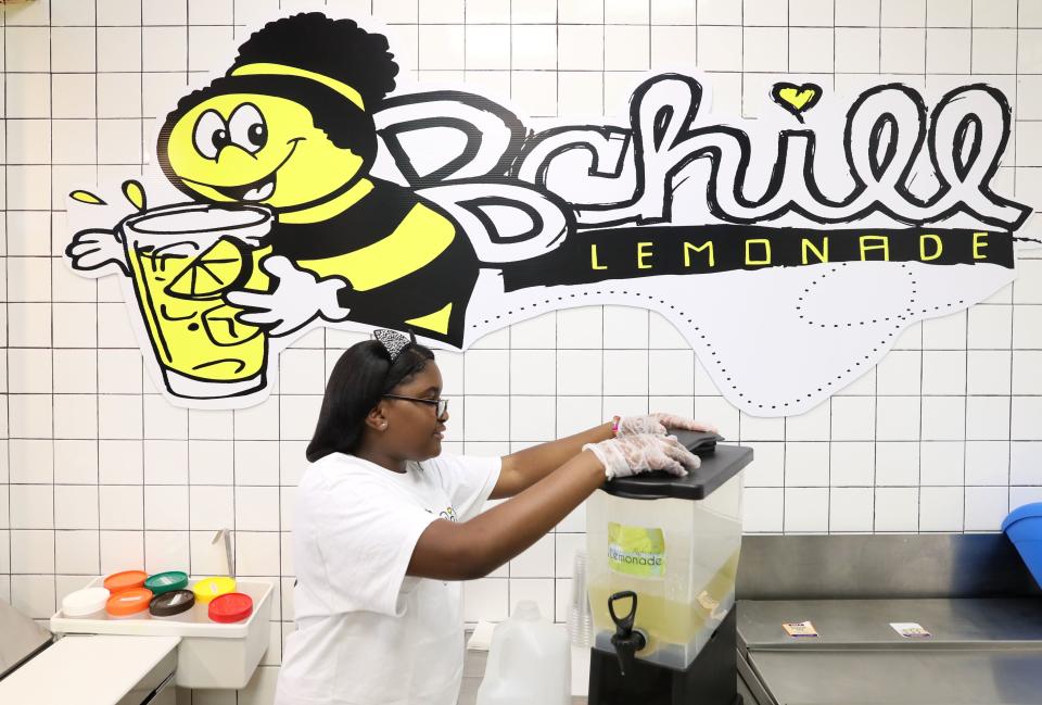 Kinyah Braddock, 10, CEO of B Chill Lemonade, prepares a dispenser of freshly squeezed lemonade at the Hickory Ridge Mall store Wednesday, May 8, 2019.