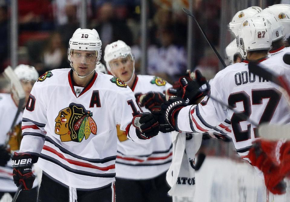 Chicago Blackhawks left wing Patrick Sharp (10) celebrates his goal against the Detroit Red Wings in the second period of an NHL hockey game Wednesday, Jan. 22, 2014, in Detroit. (AP Photo/Paul Sancya)