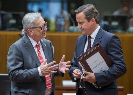 European Commission President Jean-Claude Juncker (L) talks to British Prime Minister David Cameron at the start of a European Union leaders summit in Brussels, Belgium, June 25, 2015. REUTERS/Yves Herman