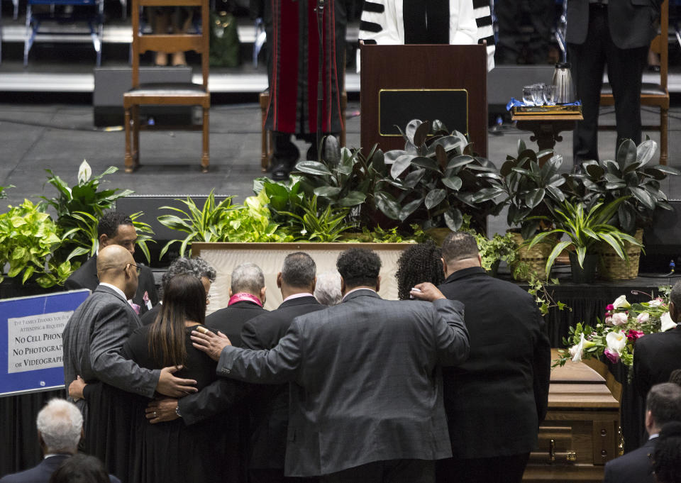 Family members gather around the casket of Katherine Johnson at the start of a memorial service in her honor on Saturday, March 7, 2020, at Hampton University Convocation Center in Hampton, Va. Johnson, a mathematician who calculated rocket trajectories and earth orbits for NASA’s early space missions and was later portrayed in the 2016 hit film “Hidden Figures,” about pioneering black female aerospace workers died on Monday, Feb. 24, 2020. She was 101. (Kaitlin McKeown /The Virginian-Pilot via AP)