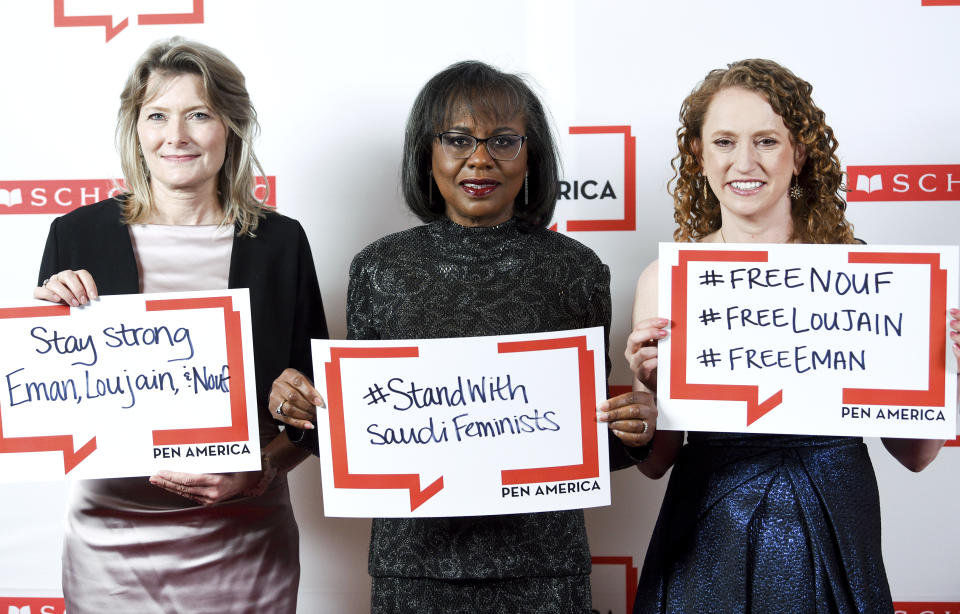 PEN America president Jennifer Egan, left, PEN courage award recipient Anita Hill and PEN America CEO Suzanne Nossel pose together holding signs in support of jailed Saudi women's rights activists Nouf Abdulaziz, Loujain Al-Hathloul and Eman Al-Nafjan at the 2019 PEN America Literary Gala at the American Museum of Natural History on Tuesday, May 21, 2019, in New York. (Photo by Evan Agostini/Invision/AP)