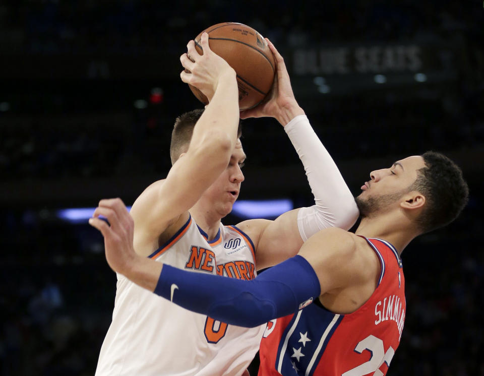 New York Knicks’ Kristaps Porzingis tries to move past Philadelphia 76ers’ Ben Simmons during the first half of the NBA basketball game, Monday, Dec. 25, 2017, in New York. (AP Photo/Seth Wenig)