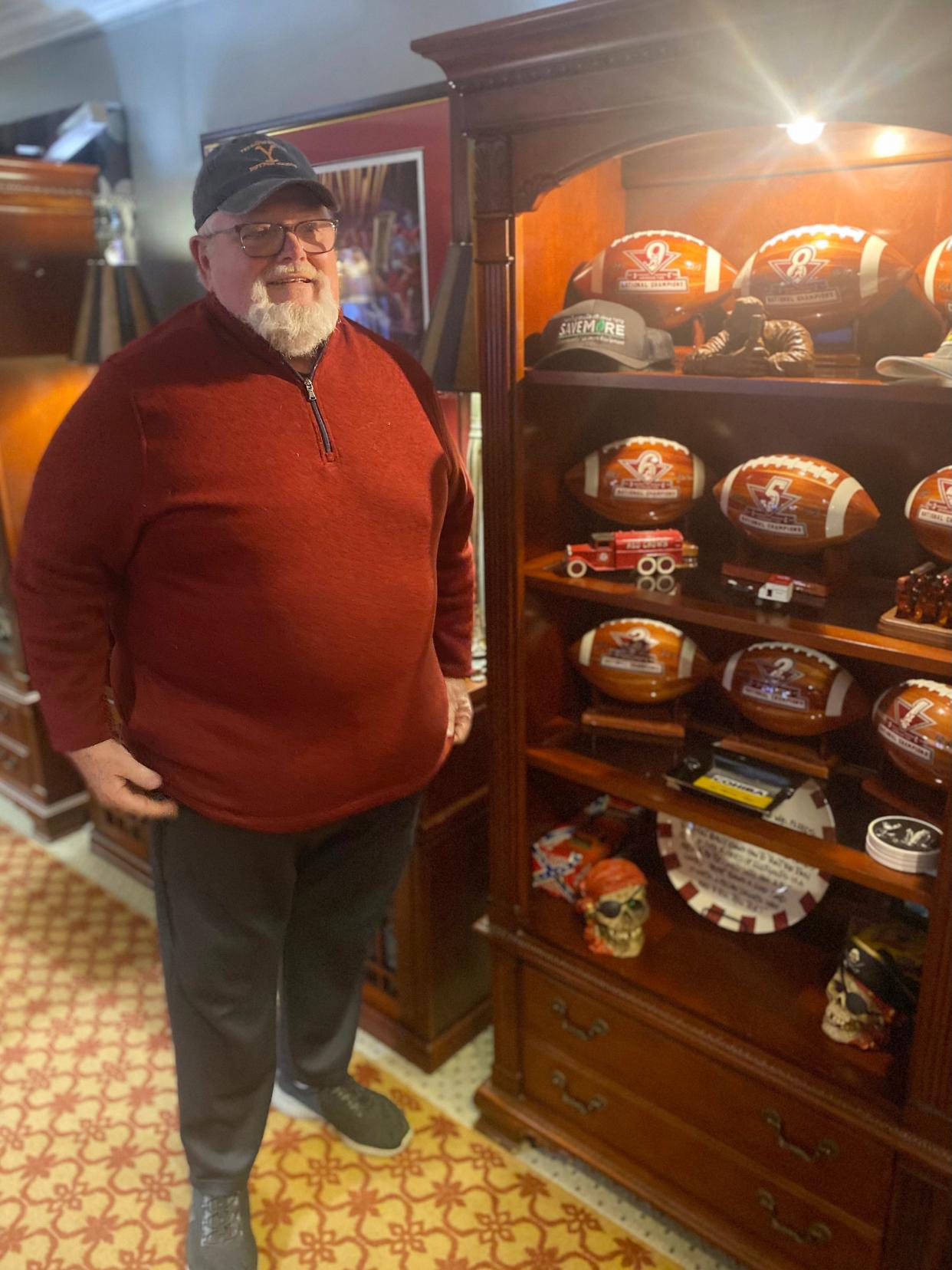 Dennis Harker is pictured with some of his University of Alabama football memorabilia.