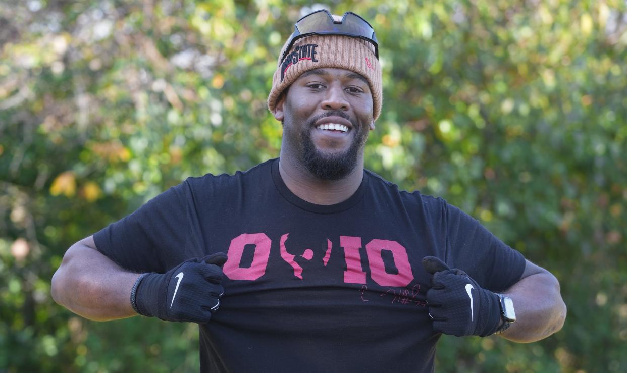 Former Ohio State offensive lineman Marcus Hall models a T-shirt that shows the famous double bird he flashed following his ejection from the 2013 Ohio State, Michigan game.