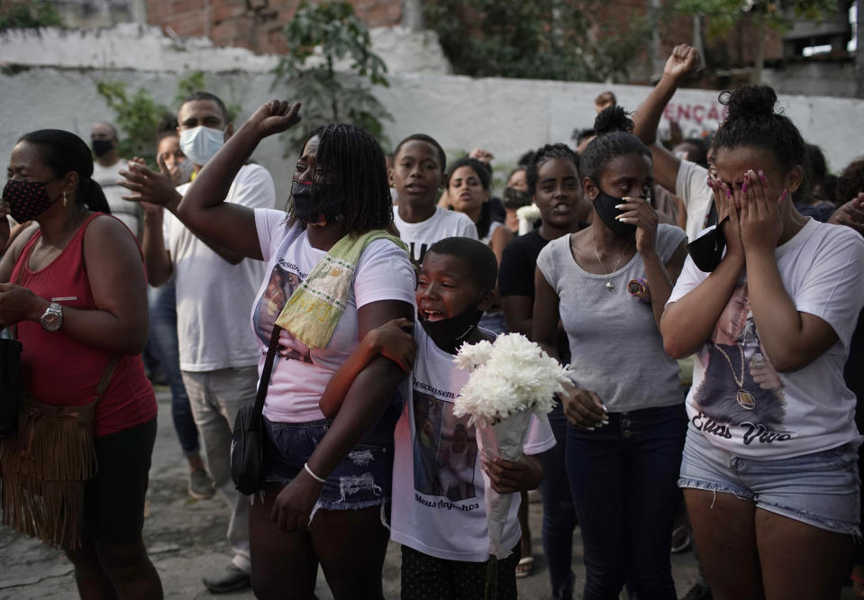 Relatives of Emily Victoria Silva dos Santos, 4, and Rebeca Beatriz Rodrigues dos Santos, 7, mourn during their burial at a cemetery in Duque de Caxias, Rio de Janeiro state, Brazil, Saturday, Dec. 5, 2020. Grieving families held funerals for Emily and Rebeca, killed by bullets while playing outside their homes. Weeping and cries of “justice” were heard Saturday at their funerals, reflecting the families’ assertion that the children were killed by police bullets. (AP Photo/Silvia Izquierdo)