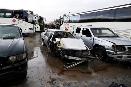 Damaged vehicles are pictured at the site of an attack by two suicide bombers in Damascus, Syria March 11, 2017. REUTERS/Omar Sanadiki