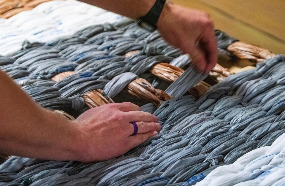 Volunteers help create sleeping mats for the homeless from plastic shopping bags as part of the bag ministry at Dalraida Global Methodist Church in Montgomery, Ala., on Thursday April 4, 2024.