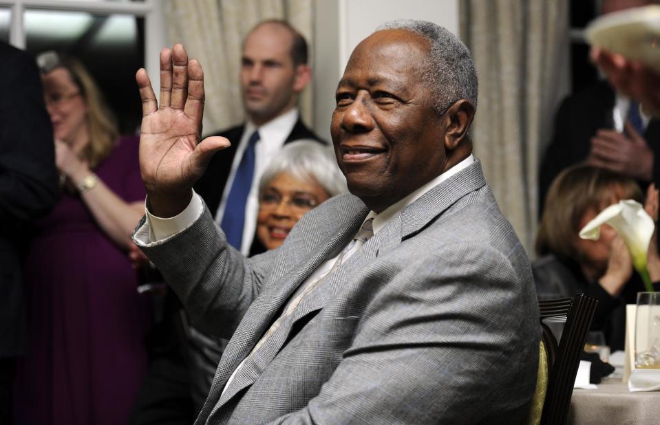 FILE - In this Feb. 7, 2014 file photo, baseball Hall of Famer Hank Aaron waves during a reception in his honor in Washington. The 40th anniversary of Hank Aaron's 715th home run finds the Hall of Famer, now 80, coping with his recovery from hip surgery. The anniversary of his famous homer on April 8, 1974 will be celebrated before the Braves' home opener against the Mets on Tuesday night. (AP Photo/Nick Wass, File)