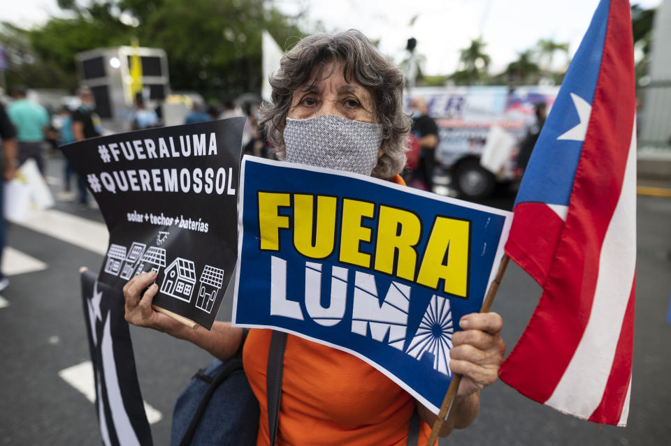 People march along Las Americas Highway to protest the LUMA Energy company in San Juan, Puerto Rico, Friday, Oct. 15, 2021. Ever since LUMA began providing service over the summer, hundreds of thousands of Puerto Ricans have had to deal with widespread blackouts for extended periods of time, voltage fluctuations and bad customer service along with an increase in pricing. (AP Photo/Carlos Giusti)