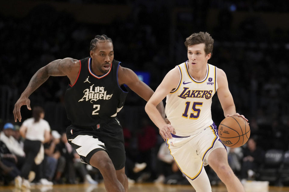 Los Angeles Lakers guard Austin Reaves (15) drives against Los Angeles Clippers forward Kawhi Leonard (2) during the first half of an NBA basketball game in Los Angeles, Sunday, Jan. 7, 2024. (AP Photo/Eric Thayer)