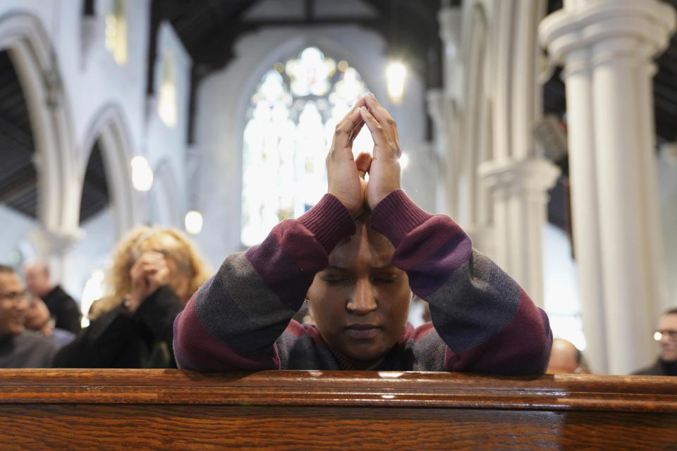 In this Sunday, Dec. 15, 2019, photo, Diely Martinez, 30, prays inside the Holyrood Episcopal Church-Iglesia Santa Cruz in New York. Martinez started volunteering as a sermon interpreter after her mother, who is deaf, began attending the church last year. (AP Photo/Emily Leshner)