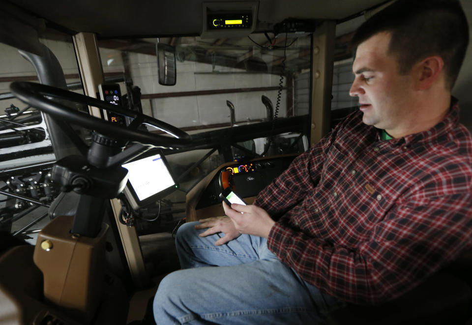 Nick Guetterman looks over the data shared by his crop sprayer and cell phone while on his farm near Bucyrus, Kan., Wednesday, Feb. 19, 2014. Farmers from across the nation gathered in Washington this month for their annual trek to seek action on the most important matters in American agriculture. But this time, a new issue emerged: growing unease about how the largest seed companies are gathering vast amount of data from sensors on tractors, combines and other farm equipment. The sensors measure soil conditions, seeding rates, crop yields and many other variables. (AP Photo/Orlin Wagner)