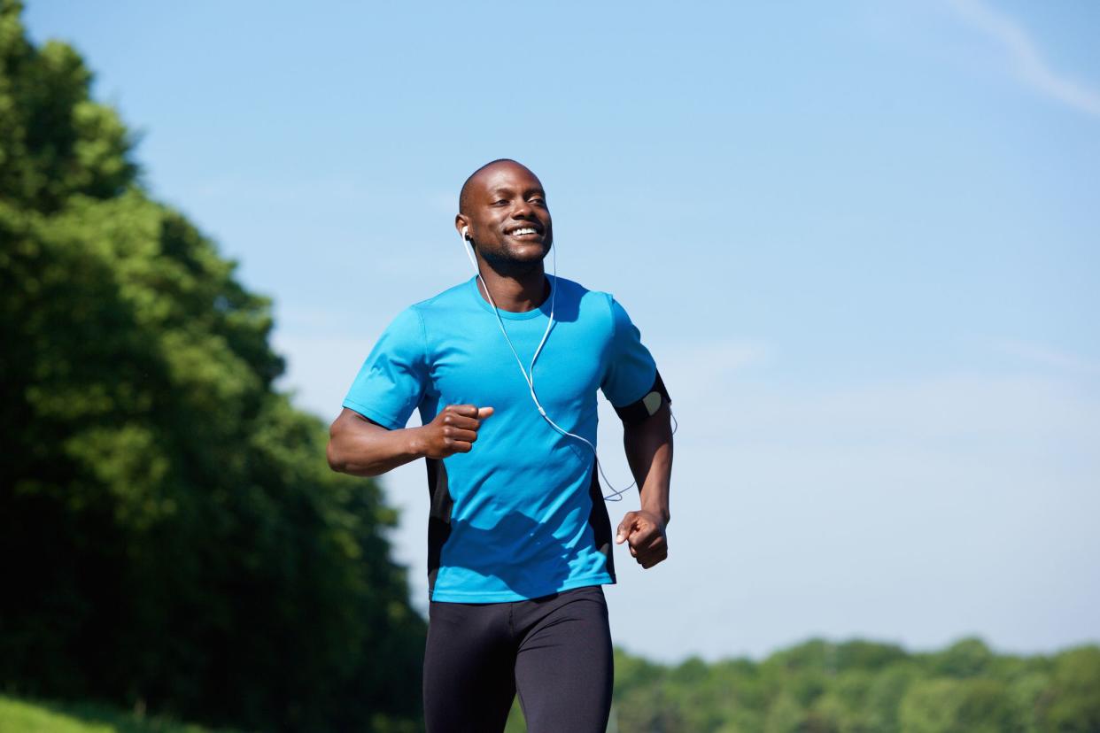 Portrait of an active african american man running exercise workout outdoors