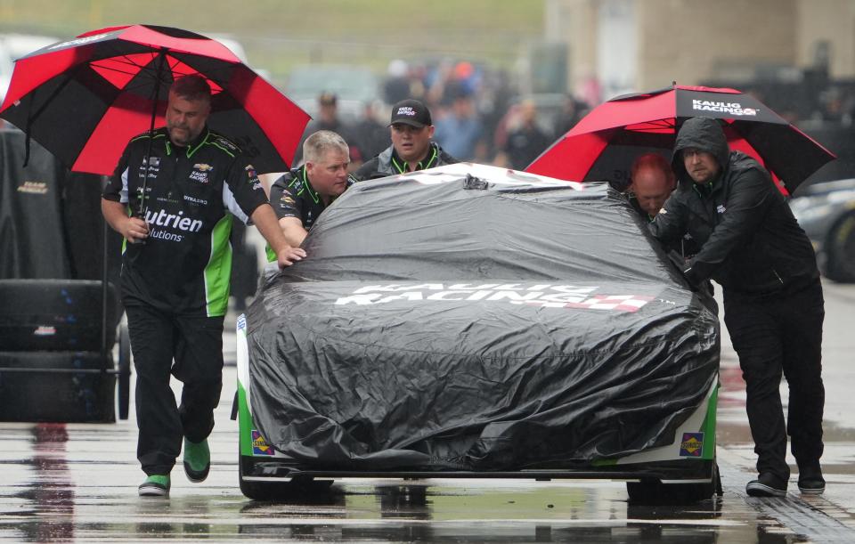 Crew members prepare for Friday's practice runs during late morning rains in advance of Sunday's NASCAR EchoPark Automotive Grand Prix race at Circuit of the Americas.