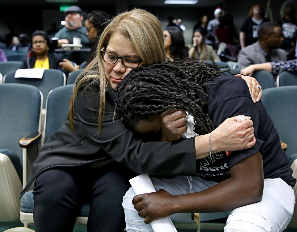 FILE - In this April 9, 2019, file photo, Elizabeth Medrano Escobedo, left, mother of Christian Escobedo, who was killed by Los Angeles police, comforts Ciara Hamilton, whose cousin Diante Yarber was killed by Barstow police, during an Assembly hearing on legislation to restrict the use of deadly force by police in Sacramento, Calif. Both women both spoke in support of a bill, AB392, that would require officers to use de-escalation tactics and allow them to use deadly force only when it is necessary to prevent immediate harm to themselves or others. The bill, AB392, once was vehemently opposed by police. But it is now supported by key law enforcement groups after it was amended last week. (AP Photo/Rich Pedroncelli, File)