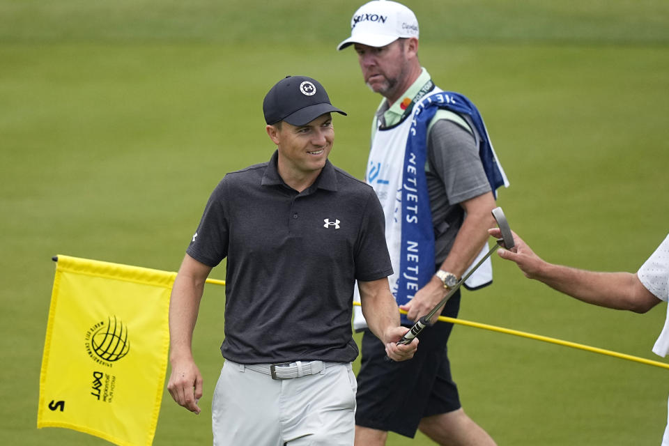 Jordan Spieth, left, hand off his putter on the second green during the third round of the Dell Technologies Match Play Championship golf tournament in Austin, Texas, Friday, March 24, 2023. (AP Photo/Eric Gay)