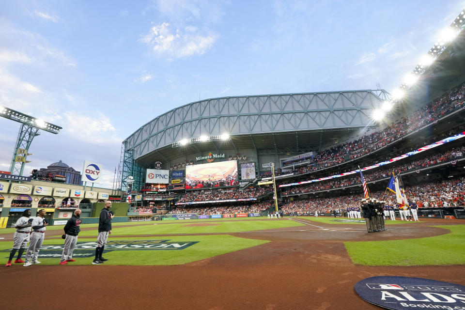 The Minnesota Twins and Houston Astros line up for the national anthem before Game 2 of an American League Division Series baseball game in Houston, Sunday, Oct. 8, 2023. (AP Photo/Tony Gutierrez)