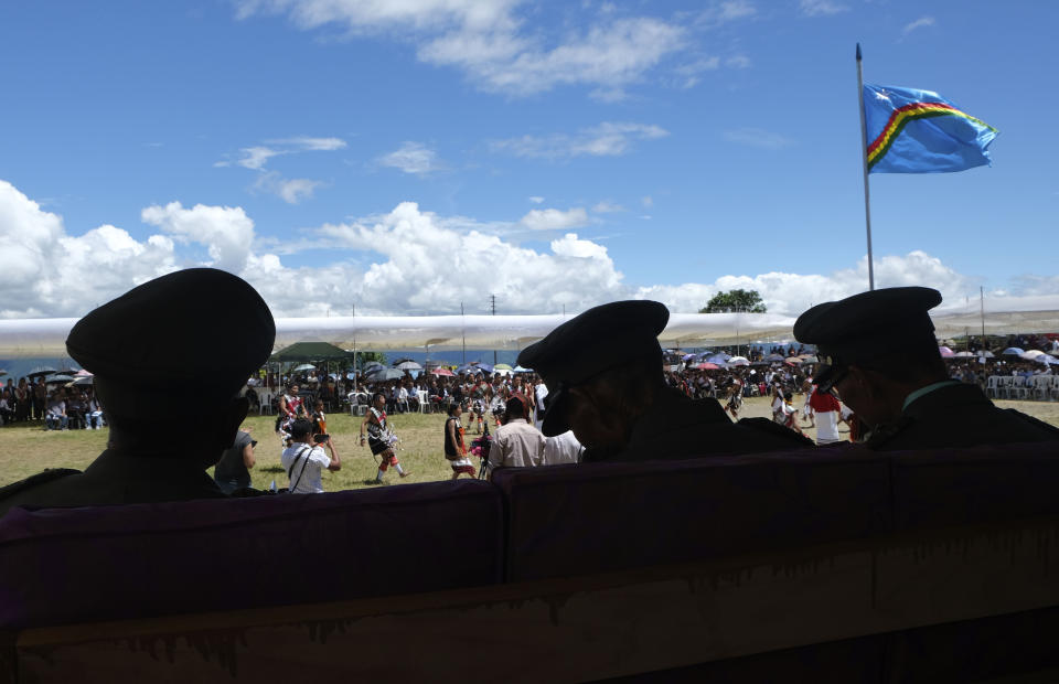 Naga Army officers watch celebrations marking their Declaration of Independence in Chedema, in the northeastern Indian state of Nagaland, Sunday, Aug. 14, 2022. The Nagas - an indigenous people inhabiting several northeastern Indian states and across the border in Myanmar - marked the 75th anniversary of their declaration of independence on Sunday. (AP Photo/Yirmiyan Arthur)