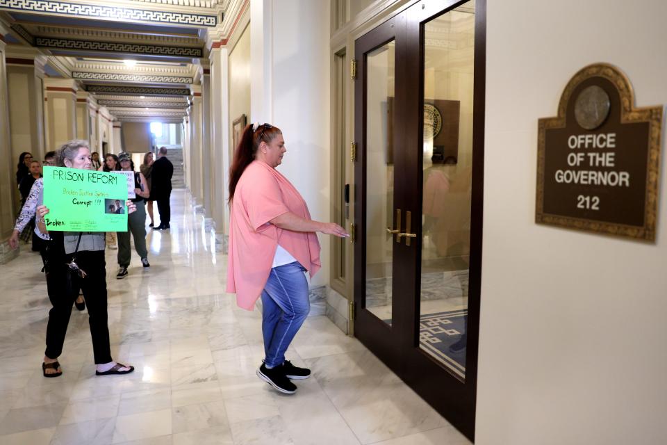 Emily Barnes, with the criminal justice advocacy group Hooked on Justice, walks to Gov. Kevin Stitt's office at the Capitol in Oklahoma City, Wednesday, May 22, 2024.