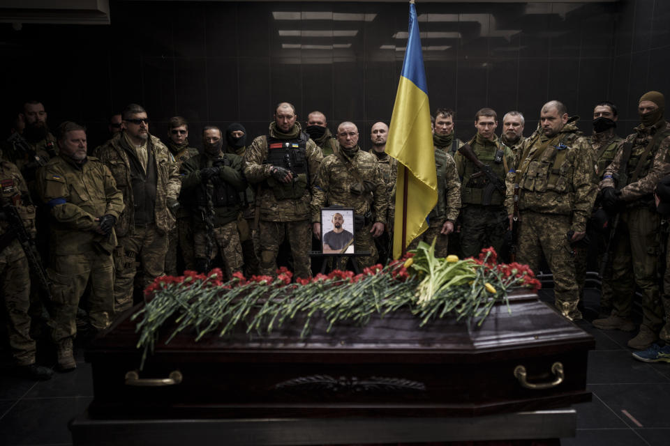 Ukrainian servicemen attend the funeral ceremony of marine Alexandr Khovtun, in Kyiv, Ukraine, Sunday, March 20, 2022. Khovtun died in combat in the town of Huta-Mezhyhirska, north of Kyiv. (AP Photo/Felipe Dana)