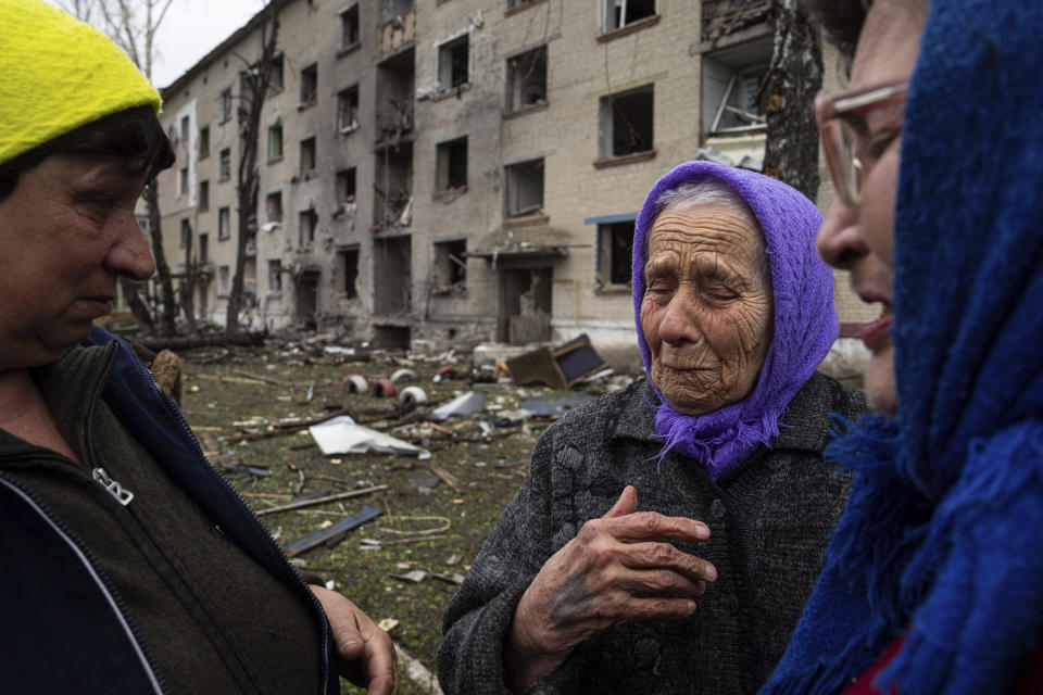 FILE - Olha Faichuk, 79, center, cries as she says goodbye to her neighbors in front of her apartment building, which was heavily damaged by a Russian airstrike, in Lukiantsi, Kharkiv region, Ukraine, on Tuesday, April 16, 2024. (AP Photo/Evgeniy Maloletka, File)