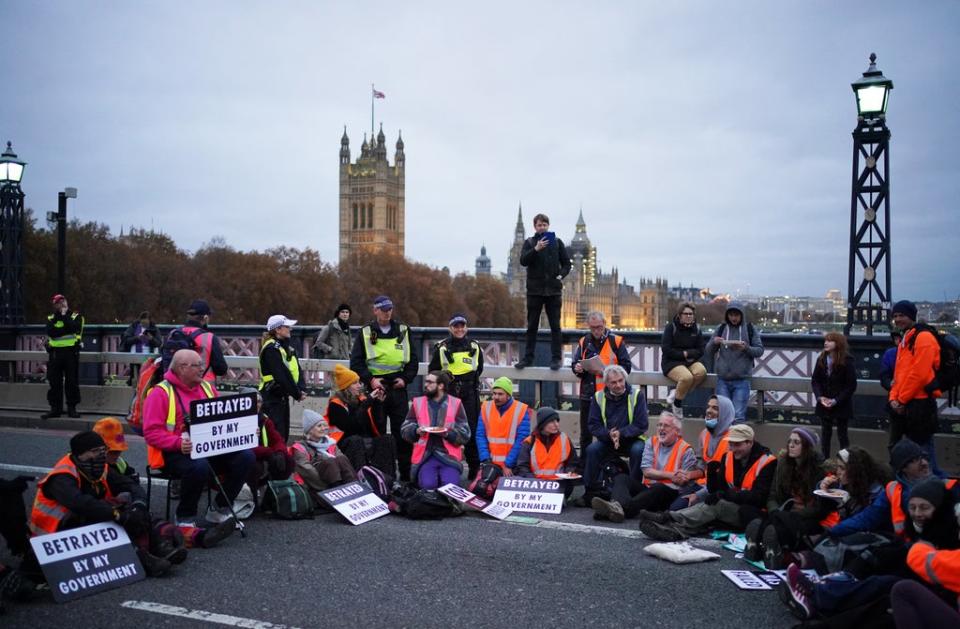 Supporters of the nine jailed Insulate Britain climate activists take part in a demonstration on Lambeth Bridge  (PA)