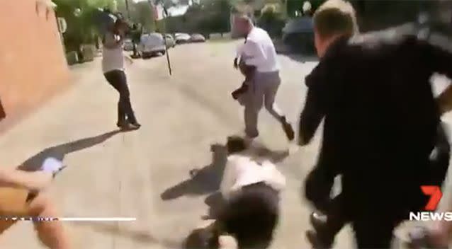 His knocks down a reporter in his wake. Photo: 7 News