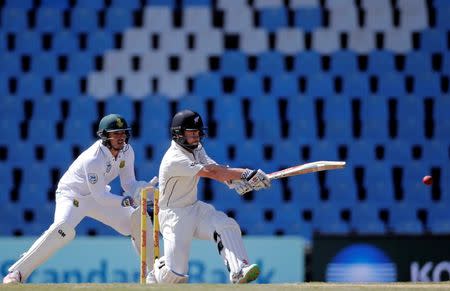 Cricket - New Zealand v South Africa - second cricket test match - Centurion Park, Centurion, South Africa - 29/8/2016. New Zealand's captain, Kane Williamson, plays a shot while South Africa's wicketkeeper Quinton de Kock looks on. REUTERS/Siphiwe Sibeko