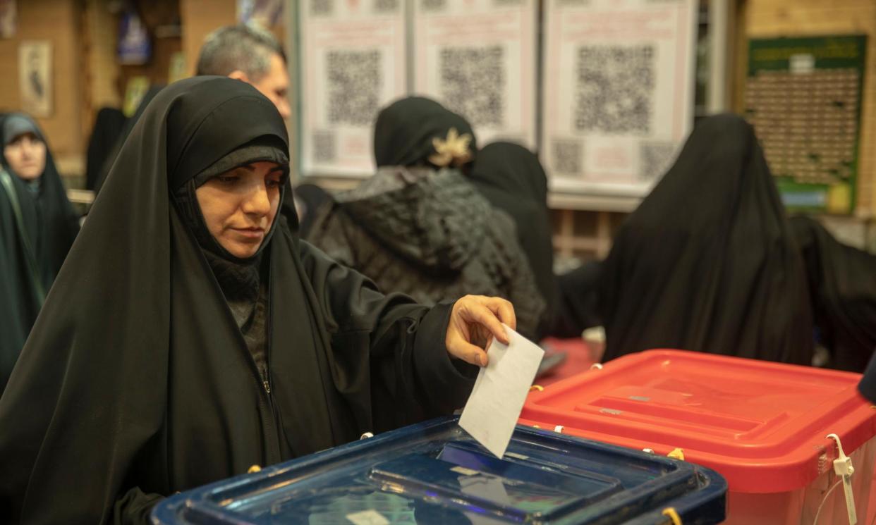 <span>A woman casting her vote in Tehran on Friday.</span><span>Photograph: Majid Saeedi/Getty Images</span>