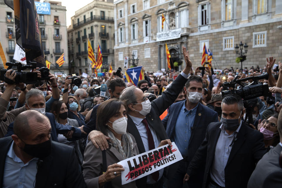 Catalonia's outgoing regional president, Quim Torra, is surrounded by Catalan pro-independence demonstrators as he leaves the Generalitat Palace in Barcelona, Spain on Monday, Sept. 28, 2020. Spain's Supreme Court has barred Catalonia's regional president from his office for refusing to remove a banner calling for the release of separatist leaders from prison that was displayed on a public building ahead of the 2019 general election (AP Photo/Emilio Morenatti)