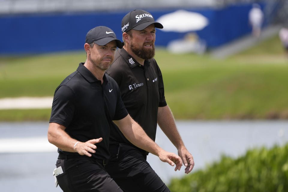 Rory McIlroy, of Northern Ireland, acknowledges the crowd as he walks onto the ninth green with teammate Shane Lowry, of Ireland, during the second round of the PGA Zurich Classic golf tournament at TPC Louisiana in Avondale, La., Friday, April 26, 2024. (AP Photo/Gerald Herbert)