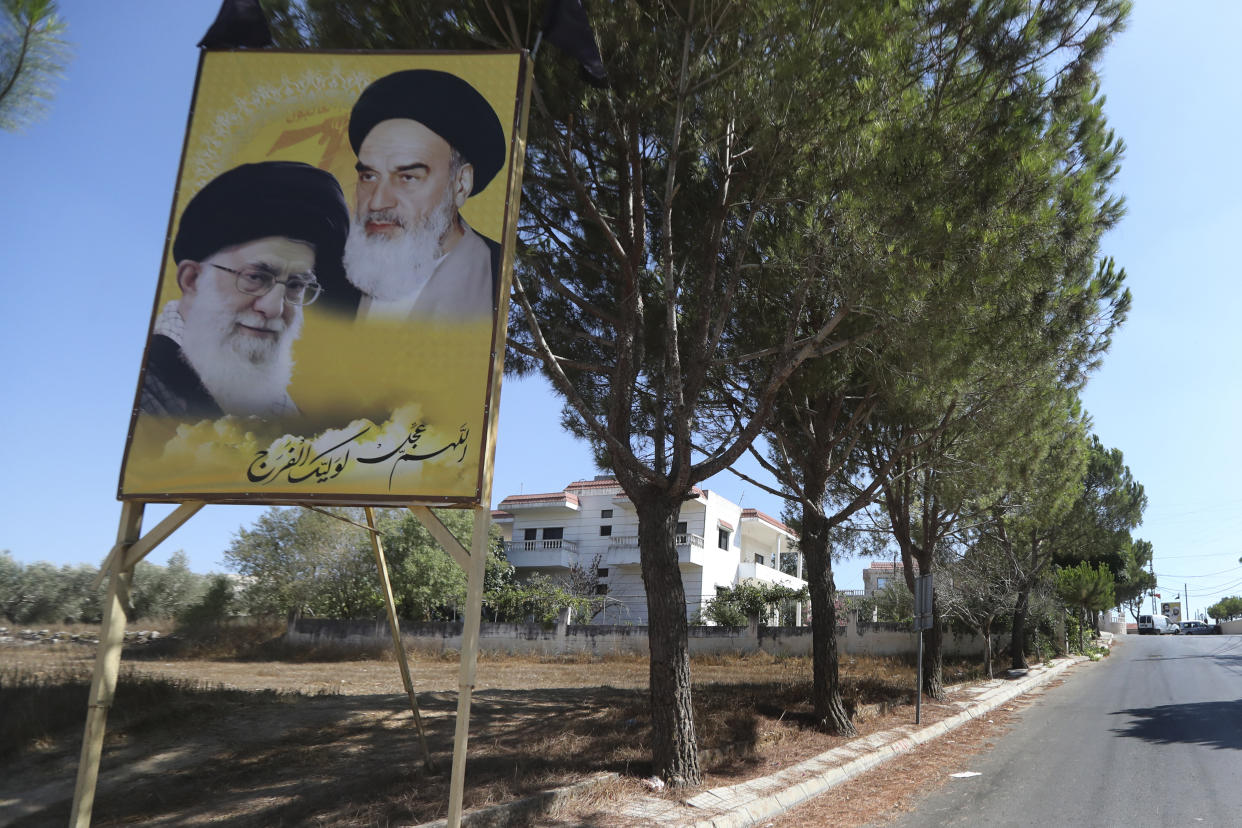 Portraits of the late revolutionary founder Ayatollah Khomeini and the Supreme Leader Ayatollah Ali Khamenei, are displayed at the entrance of the Lebanese-Israeli border village of Yaroun, south Lebanon, Saturday, Aug. 13, 2022, where the parents of Hadi Matar emigrated from. On Friday, Matar, 24, born in Fairview, N.J., attacked author Salman Rushdie during a lecture in New York. His birth was a decade after "The Satanic Verses" was first published. (AP Photo/Mohammed Zaatari)