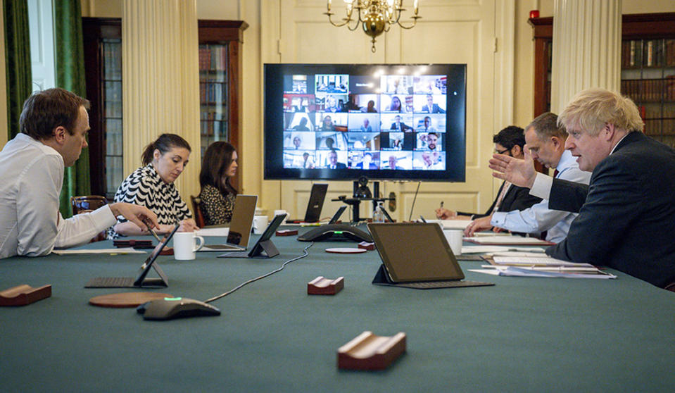 In this photo provided by 10 Downing Street, Britain's Prime Minister Boris Johnson chairs his first digital Cabinet meeting inside the Cabinet Room of No 10, since he returned to work after contracting coronavirus and the birth of his new son with his partner Carrie Symonds, in London, Thursday April 30, 2020. (Andrew Parsons/10 Downing Street/via AP)