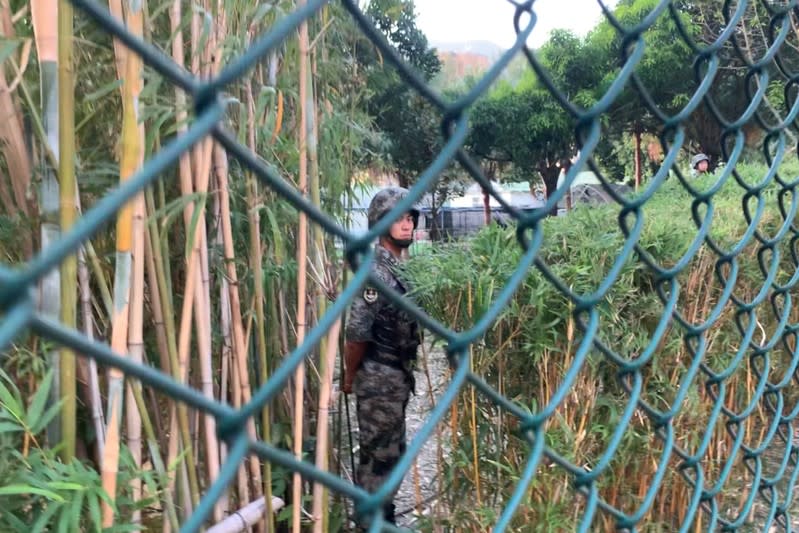 People's Liberation Army (PLA) soldier stands guard inside Osborn Barracks in Kowloon Tong