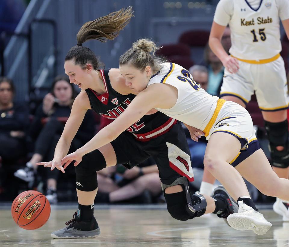 Kent State guard Abby Ogle (right) dives for a loose ball against Northern Illinois guard Laura Nickel during the second half of the Mid-American Conference Tournament quarterfinals, Wednesday, March 13, 2024, in Cleveland.