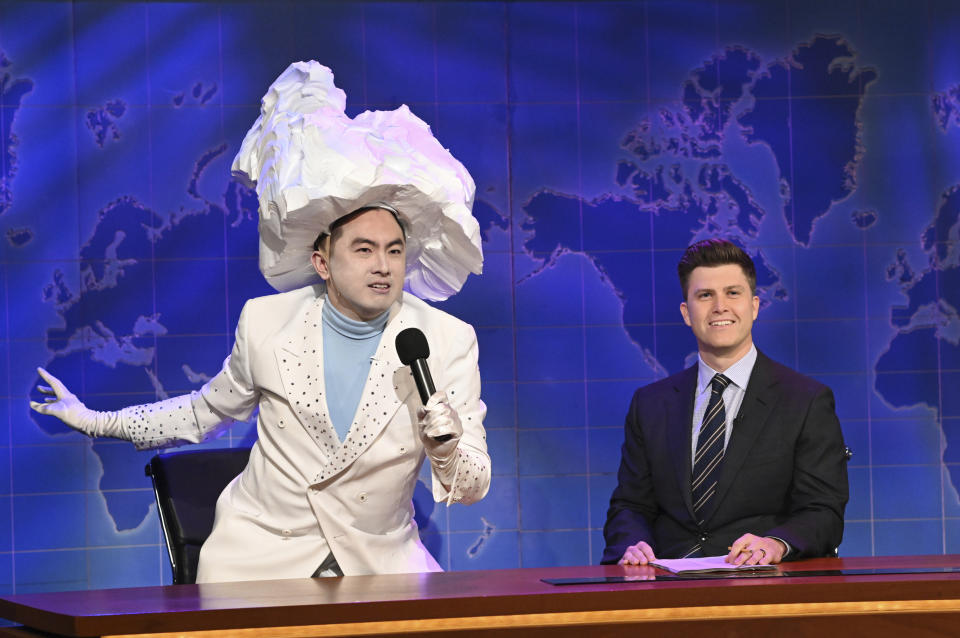 This image released by NBC shows Bowen Yang as the Iceberg that sank the Titanic, left, and anchor Colin Jost during Weekend Update on "Saturday Night Live" in New York on April 10, 2021. (Will Heath/NBC via AP)