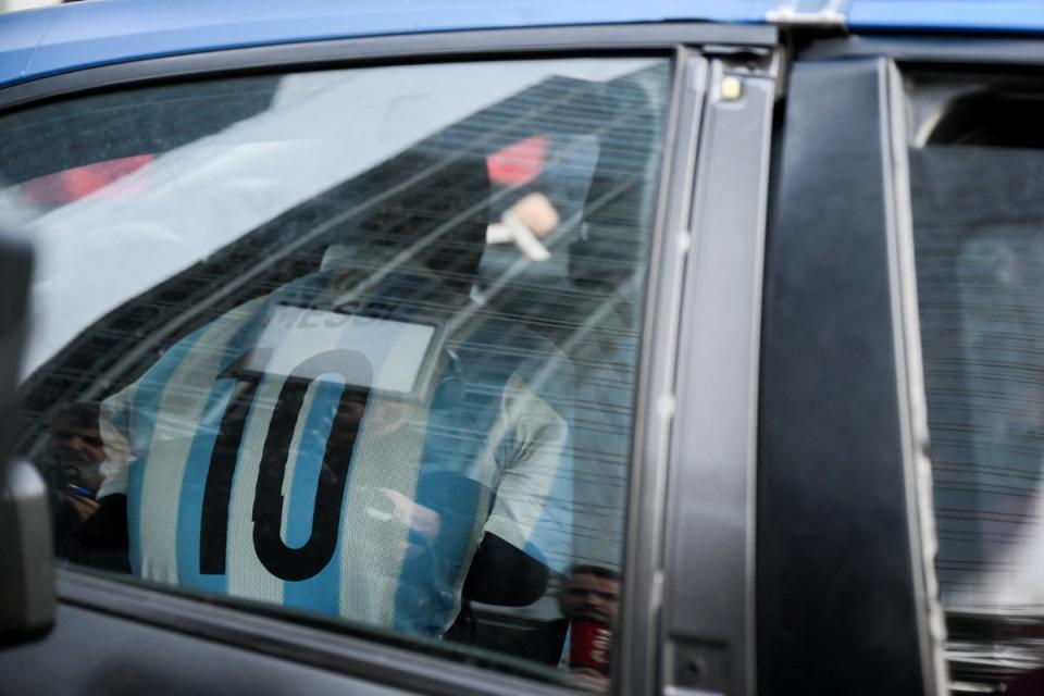 Marcin Banot being taken in a police car (AFP via Getty Images)