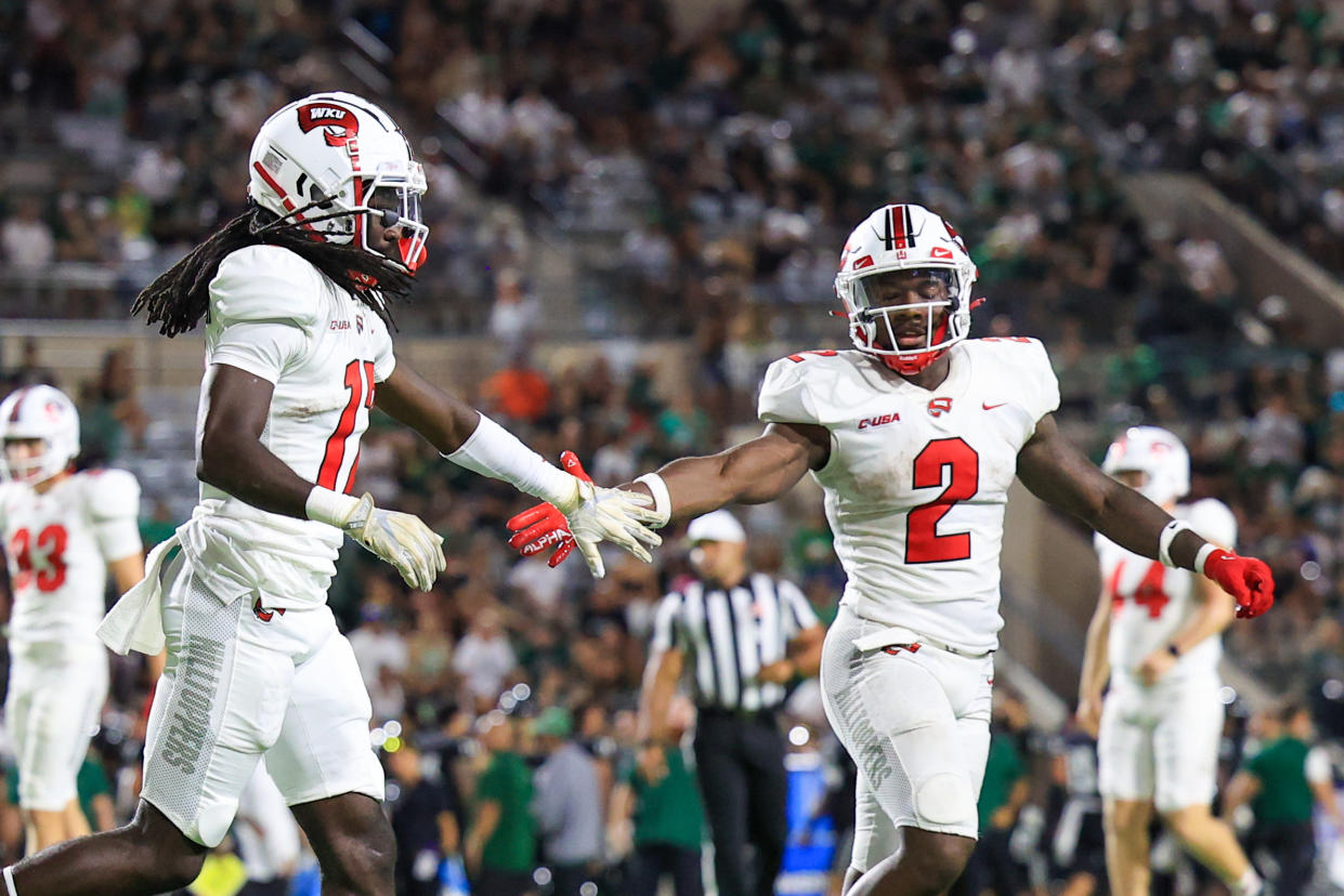 Western Kentucky's Dalvin Smith (17) is congratulated by Davion Ervin-Poindexter (2) after scoring a touchdown during a win over Hawaii on Sept. 3. (Darryl Oumi/Getty Images)