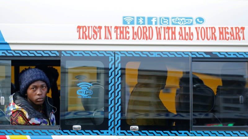 A passenger sits inside a disinfected public transport van as residents leave for the villages amid concerns over the spread of coronavirus disease (COVID-19) in Nairobi