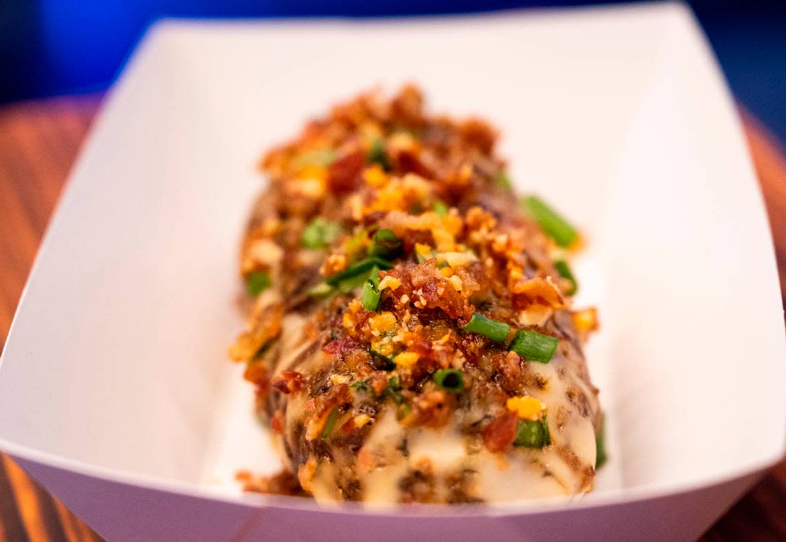 Chef Molly de Mers has developed creative options that are still feasible at mass-scale, such as this hasselback potato with cheese sauce, scallions and crunchy candied bacon bits.