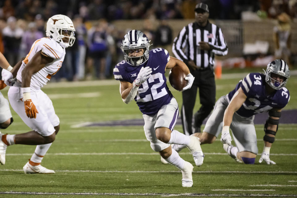 FILE - Kansas State running back Deuce Vaughn (22) carries the ball against Texas during the second half of an NCAA college football game Saturday, Nov. 5, 2022, in Manhattan, Kan. The body types are certainly much different for TCU's Kendre Miller and Kansas State's 5-foot-6 dynamo Deuce Vaughn. And yet the running backs that will be featured in the Big 12 championship game look pretty similar in what they do on the field. (AP Photo/Reed Hoffmann, File)