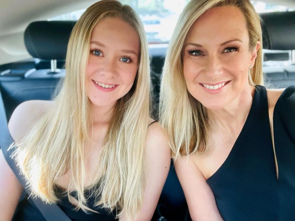 TV personality Melissa Doyle with her lookalike daughter, 17-year-old Talia wearing formal dresses in the back of a car