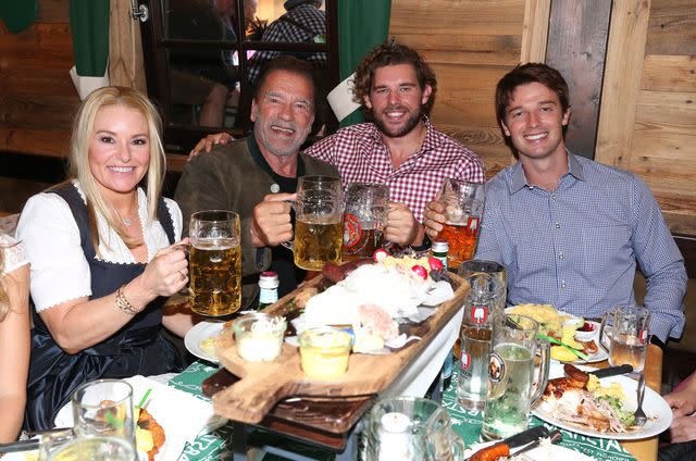 <p>Gisela Schober/Getty</p> Heather Milligan, Arnold Schwarzenegger and sons Christopher and Patrick on September 24, 2022 in Munich, Germany.