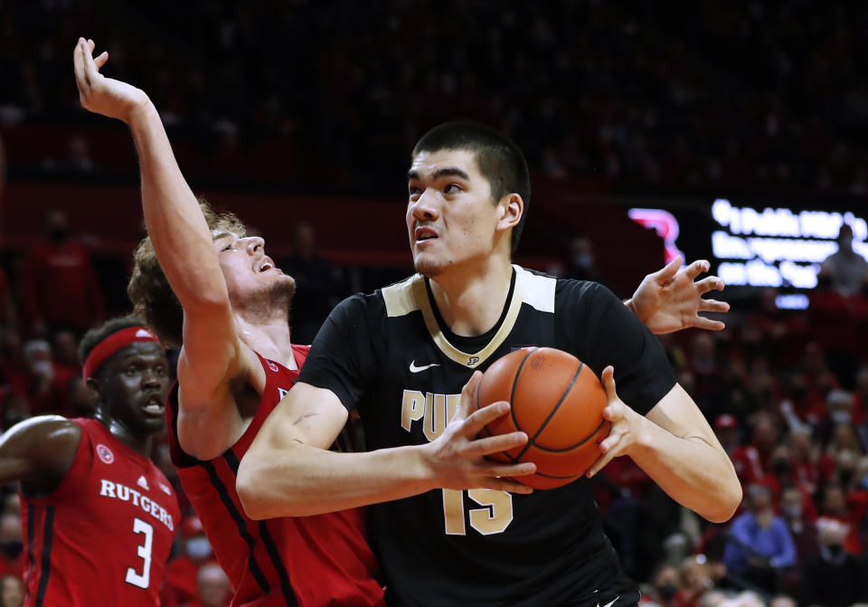 Purdue center Zach Edey (15) goes to the basket against Rutgers forward Dean Reiber during the first half of an NCAA college basketball game in Piscataway, N.J., Thursday, Dec. 9, 2021. (AP Photo/Noah K. Murray)