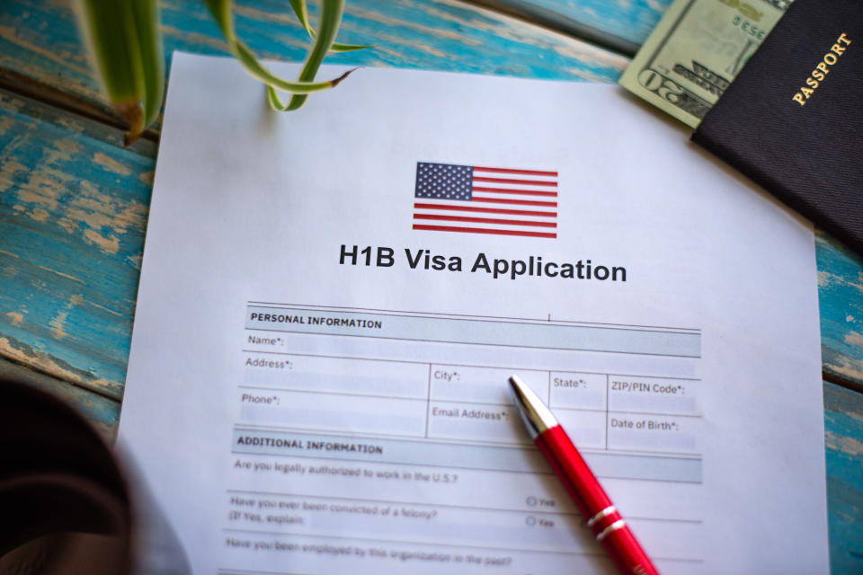 Illustrative picture showing application for United States of America work visa H1B with pen