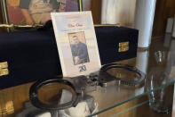 This July 15, 2021 image shows handcuffs that belonged to Elias Otero in a memorial hutch at his family's home in Albuquerque, New Mexico. Otero, 24, had served nearly four years as a corrections officer before switching careers. He was shot to death outside his home in February. No arrests have been made. Homicide rates in many American cities have continued to rise although not as precipitously as the double-digit jumps seen in 2020 and still below the violence of the mid-90s. (AP Photo/Susan Montoya Bryan)