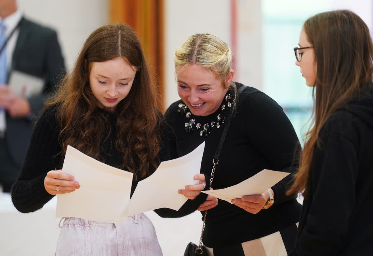 Jessica McGeown (left) opens her A-level results with her mother Samantha McGeown at Lagan College, Belfast (PA) (PA Wire)