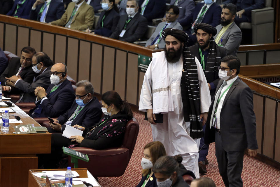 The acting foreign minister in Afghanistan's new Taliban-run Cabinet, Amir Khan Muttaqi, center, arrives for the 17th extraordinary session of Organization of Islamic Cooperation (OIC) Council of Foreign Ministers, in Islamabad, Pakistan, Sunday, Dec. 19, 2021. The economic collapse of Afghanistan, already teetering dangerously on the edge, would have a "horrendous" impact on the region and the world, successive speakers warned Sunday at the start of a one-day summit of foreign ministers. (AP Photo/Rahmat Gul)