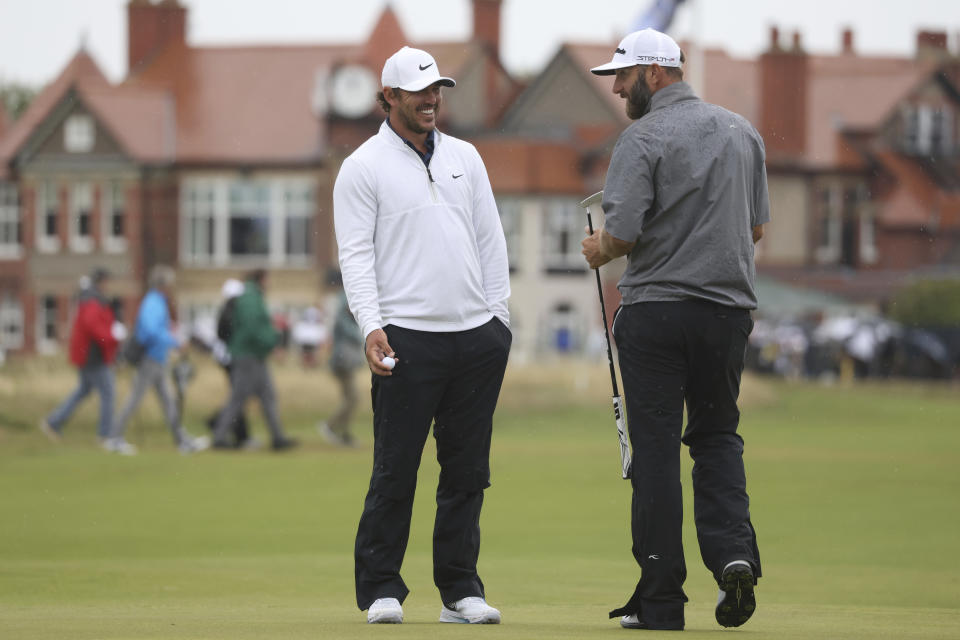 United States' Brooks Koepka, left and United States' Dustin Johnson chat as they putt on the 3rd green during a practice round for the British Open Golf Championships at the Royal Liverpool Golf Club in Hoylake, England, Tuesday, July 18, 2023. The Open starts Thursday, July 20. (AP Photo/Peter Morrison)